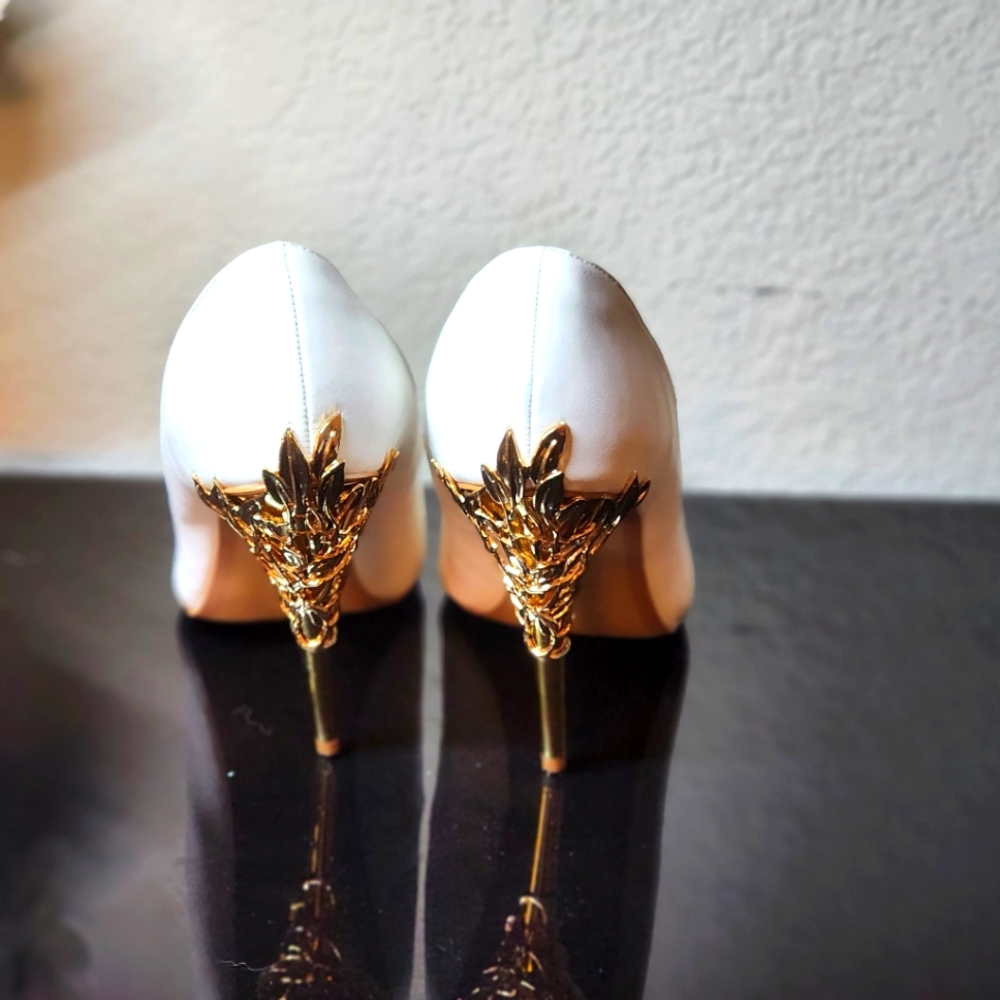 New with box worn once. White leather with gold design heels. Size 9 wide